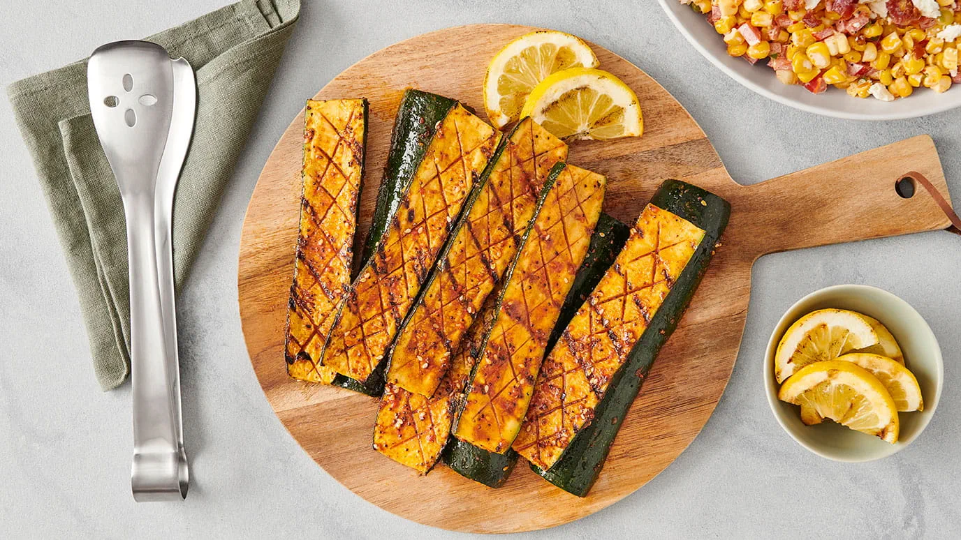 Tray of Grilled Zucchini with Lemon Wedges