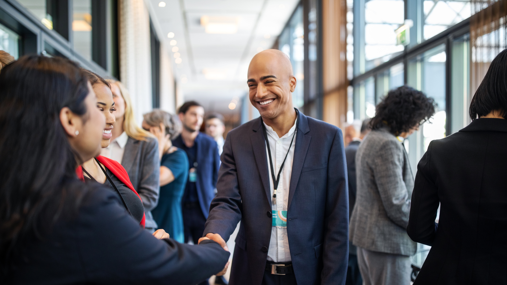 Business executives handshaking at convention center