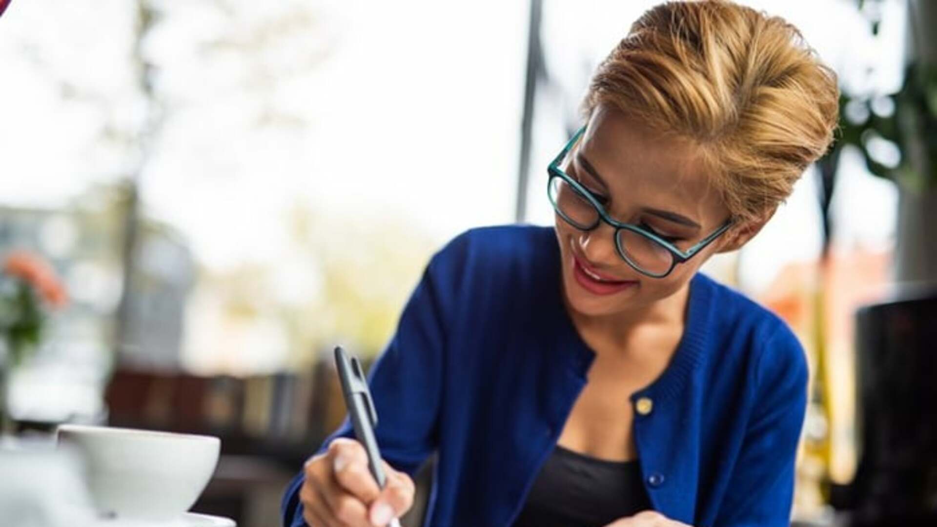 Smiling woman reviewing papers.jpeg