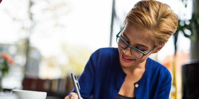 Smiling woman reviewing papers.jpeg