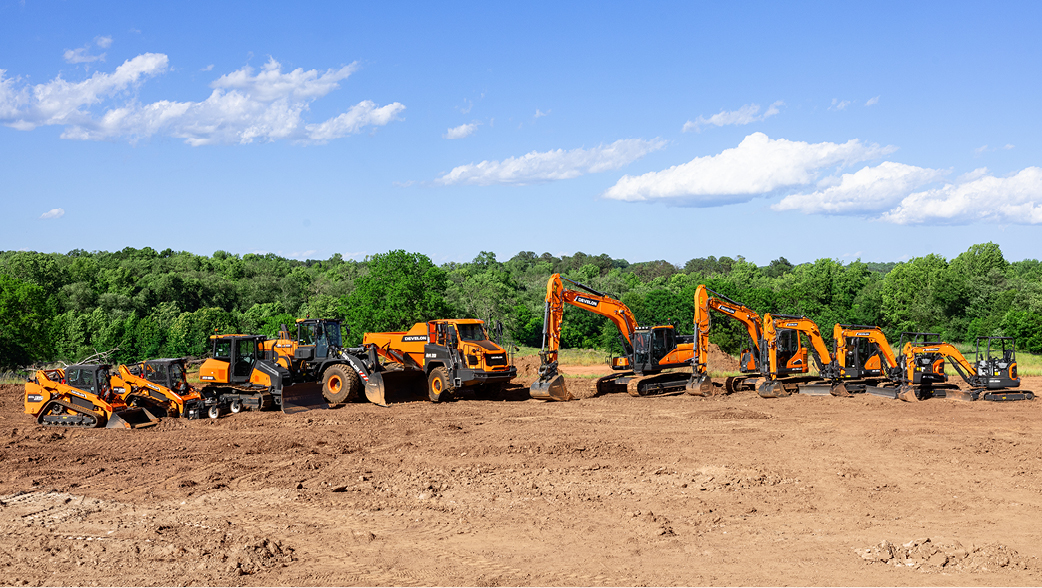 The DEVELON full equipment lineup on display at a job site.