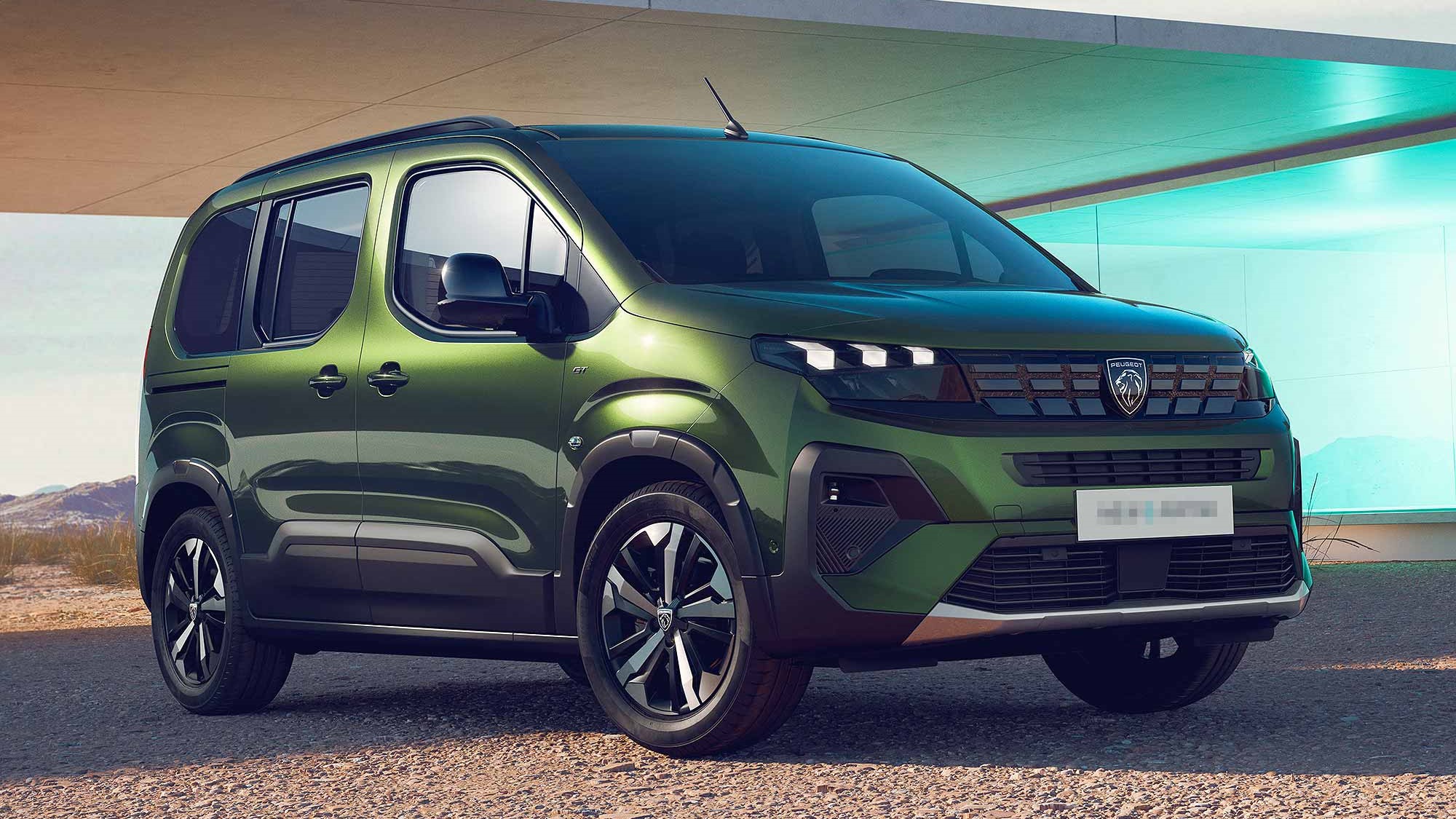 A metallic green Peugeot Rifter parked in the countryside