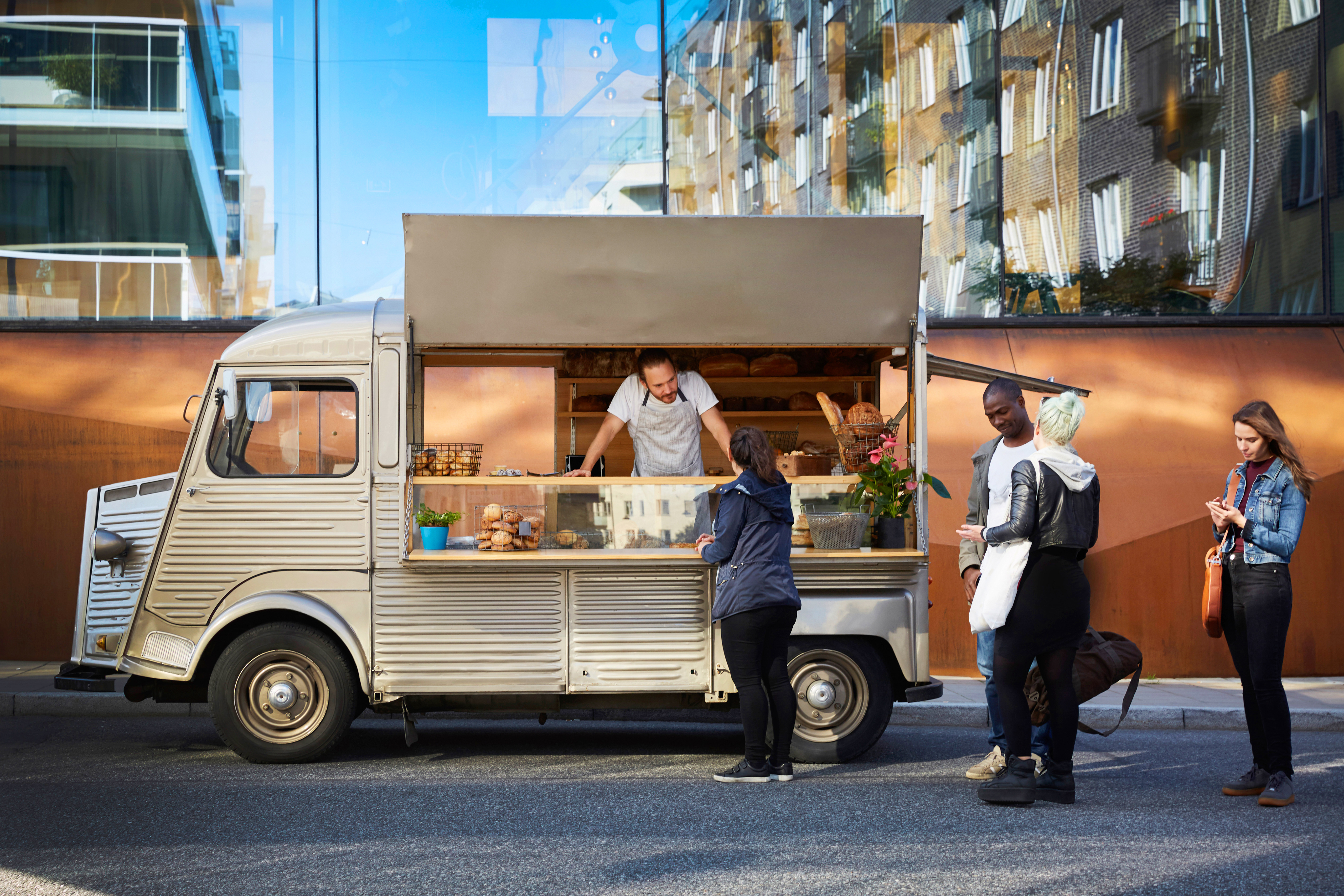 people stand by a food truck