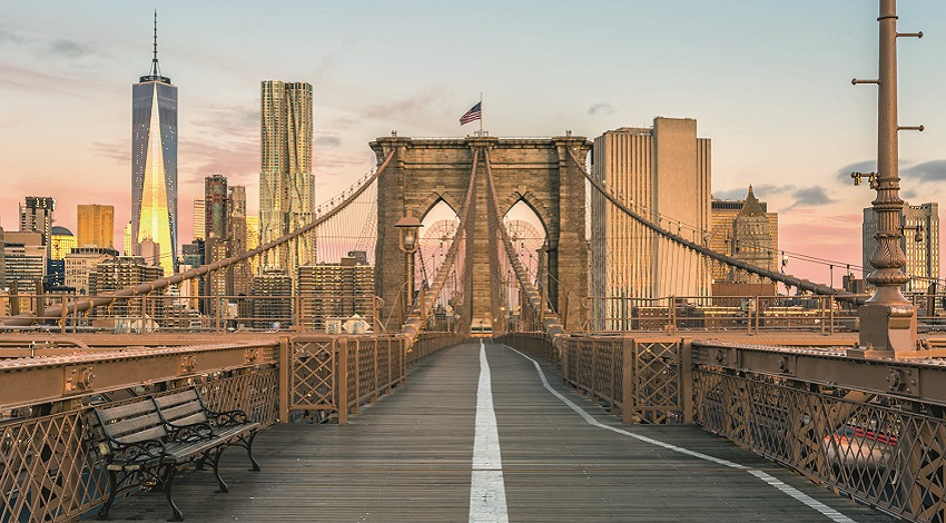 A view overlooking the New York City skyline from one of its bridges