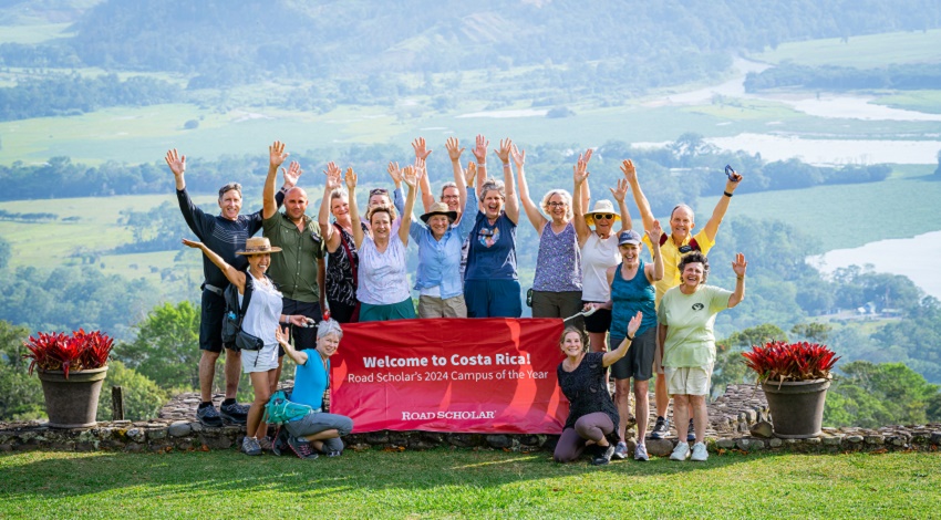Road Scholars raise their hands in celebration of Costa Rica, our 2024 Campus of the Year