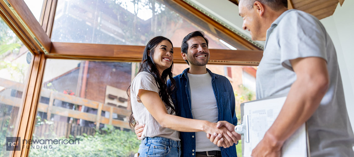 homeowners shaking hands with contractor