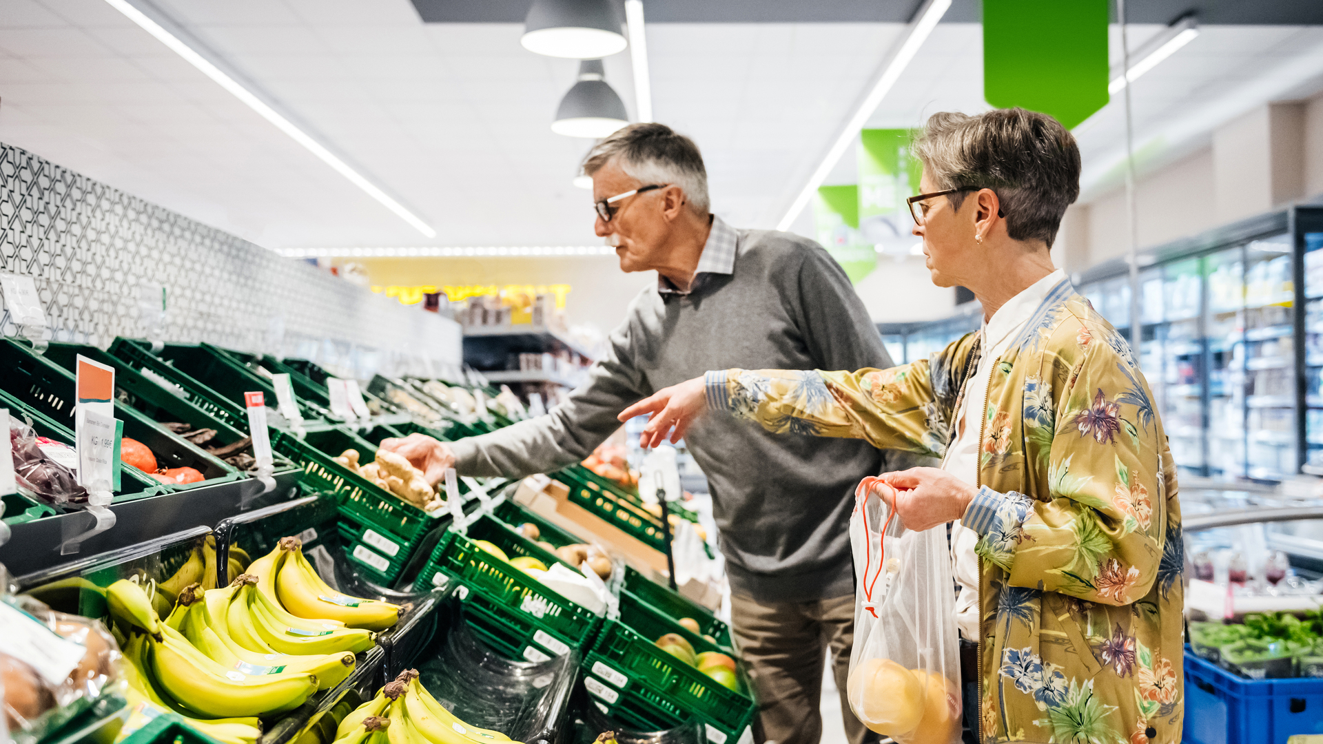 Senior Couple Buying Fruit And Vegetables Together