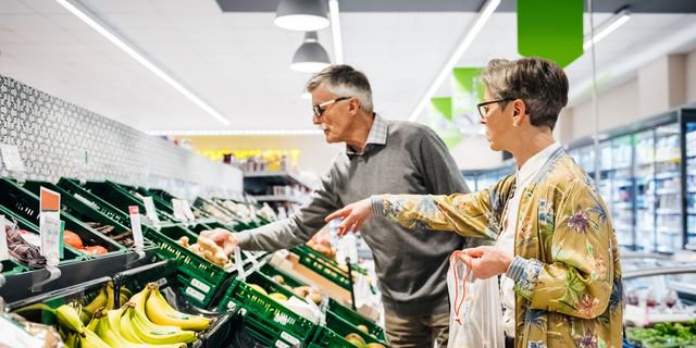 Senior Couple Buying Fruit And Vegetables Together