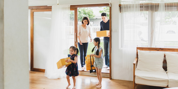 family with cute young girls moving into their new home