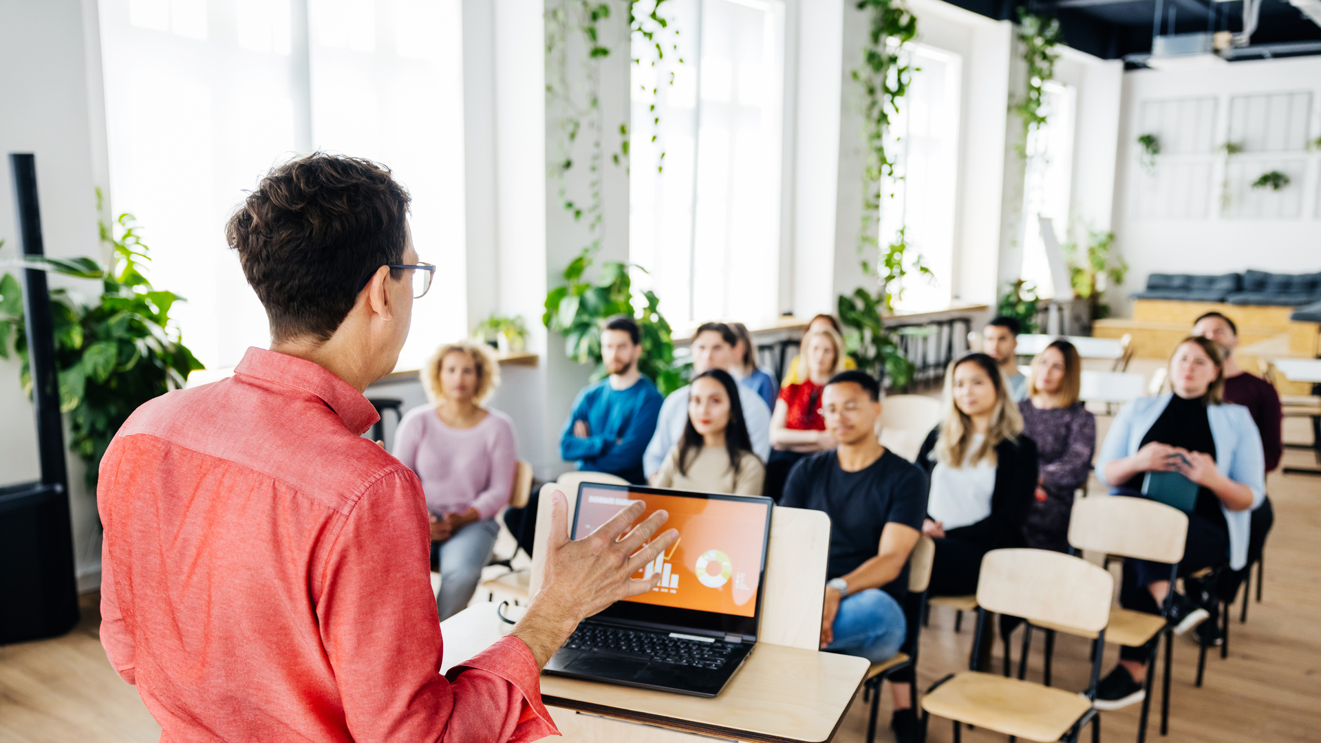 Seminar Host Giving Short Presentation To Small Audience