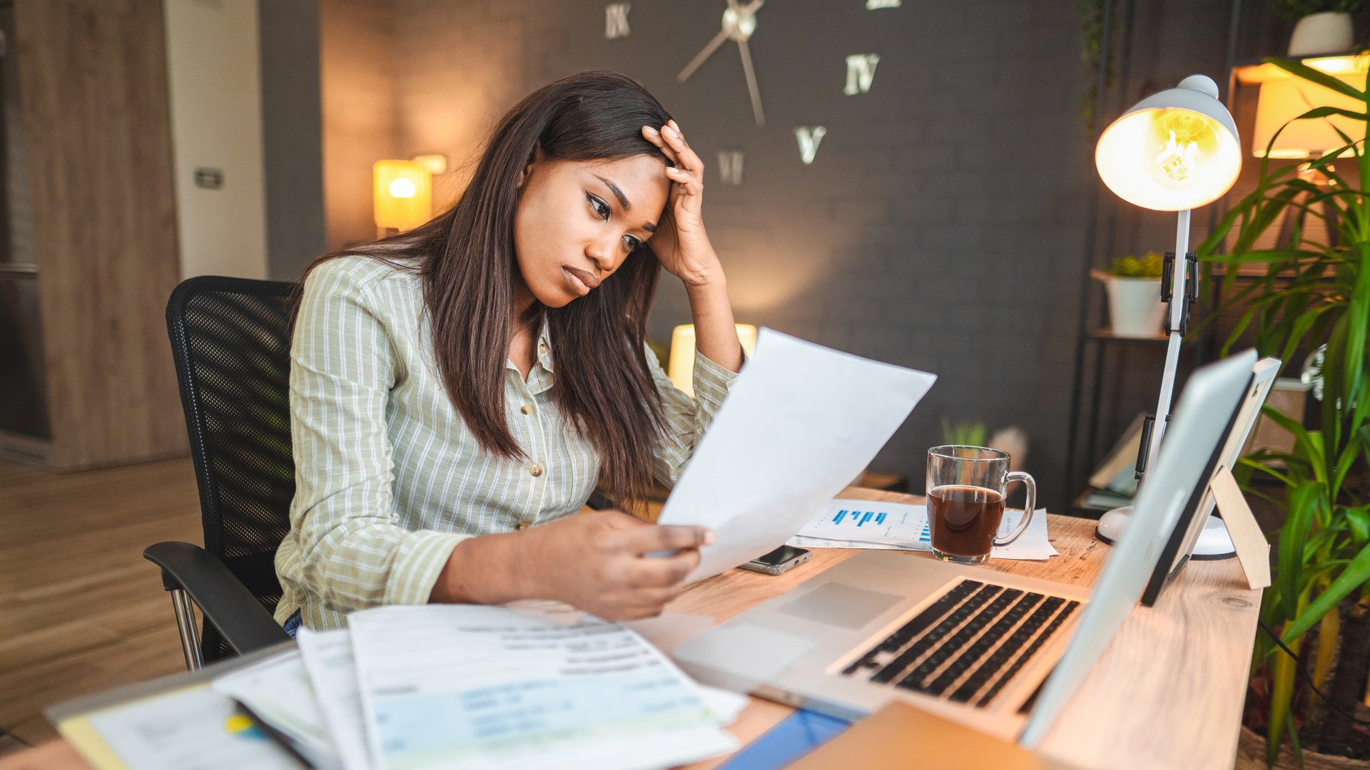 Worried young black women stressing over her financial bills