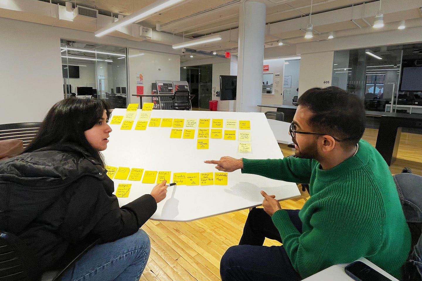 Dhar and Shankar sitting together while working on their app.