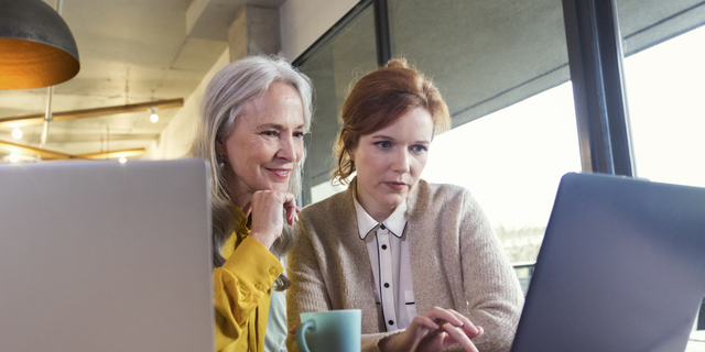 Creative businesswomen having business meeting in modern open plan office