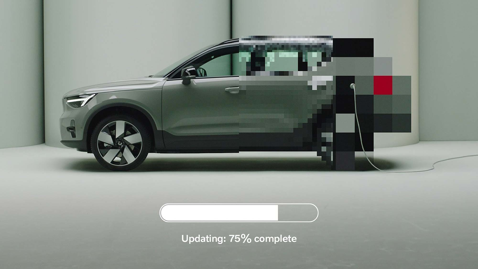 A partially pixelated electric vehicle is shown plugged in, with a software update progress bar at the bottom reading: “Updating: 75% complete.”