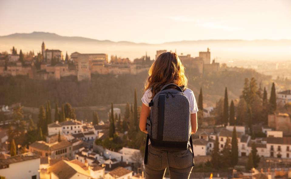 A woman traveler in Alhambra, Spain with her backpack.