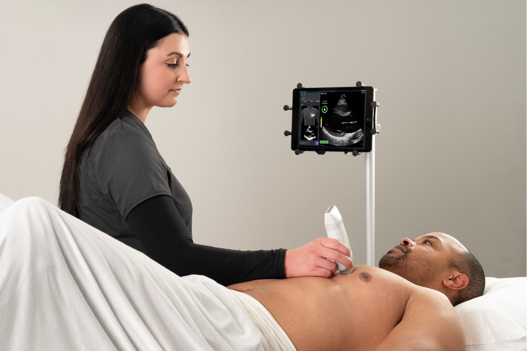 A clinician uses AI-guided ultrasound to scan a cardiac patient