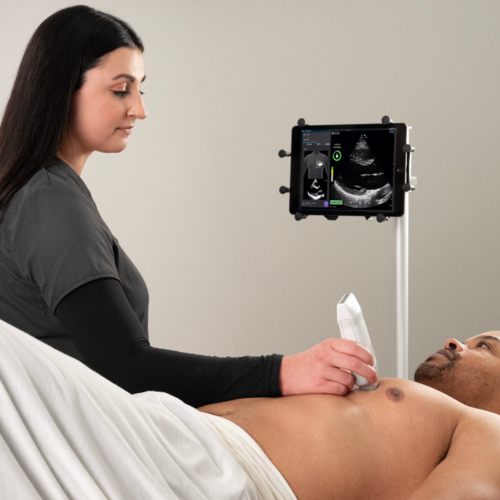 A clinician uses AI-guided ultrasound to scan a cardiac patient