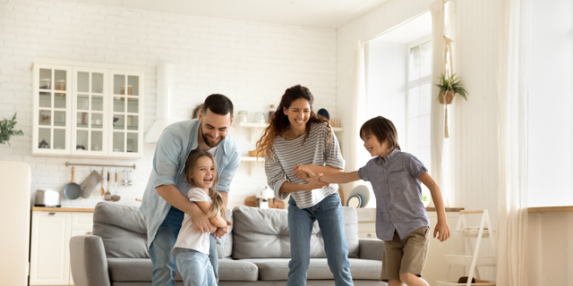 Happy family playing funny game having fun together.