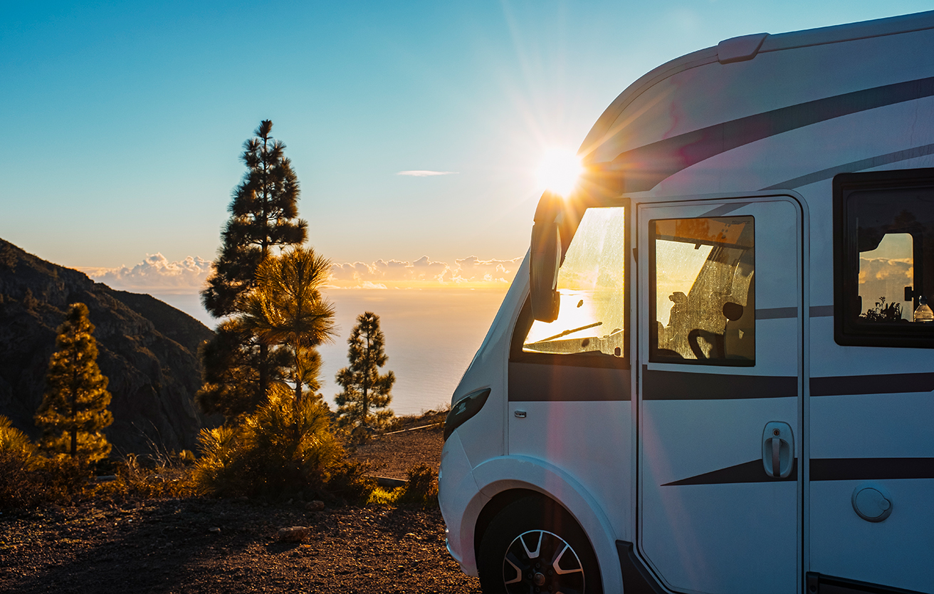 An RV parked up in the sunset