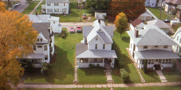 Aerial view of a row of three white houses
