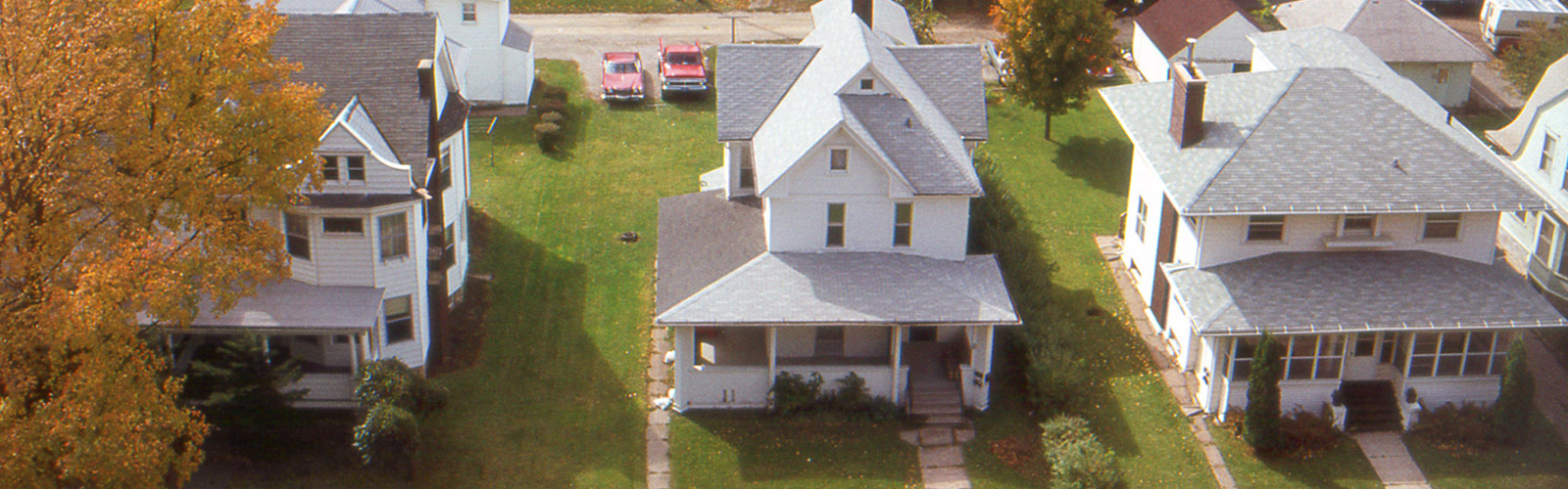 Aerial view of a row of three white houses