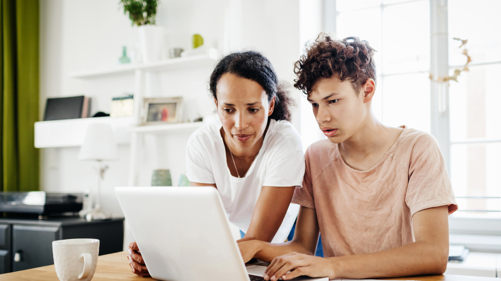 Single Mom Helping Son Study At Home