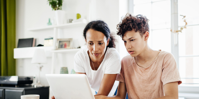 Single Mom Helping Son Study At Home