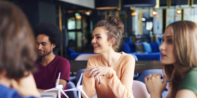 Young coworkers talking at conference table