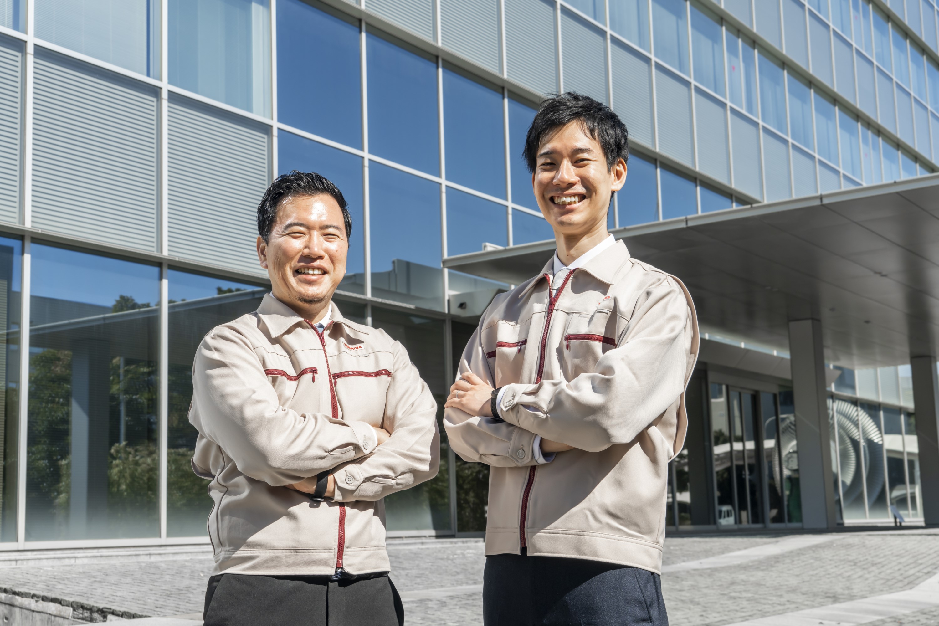 Nakahara (L) and Sugiura (R) standing in front of Isogo Nuclear Engineering Center