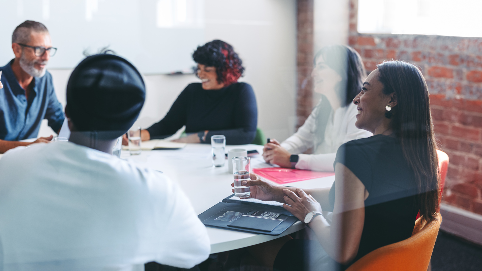 Smiling businesspeople sitting together in a meeting room