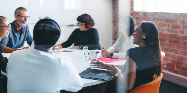 Smiling businesspeople sitting together in a meeting room