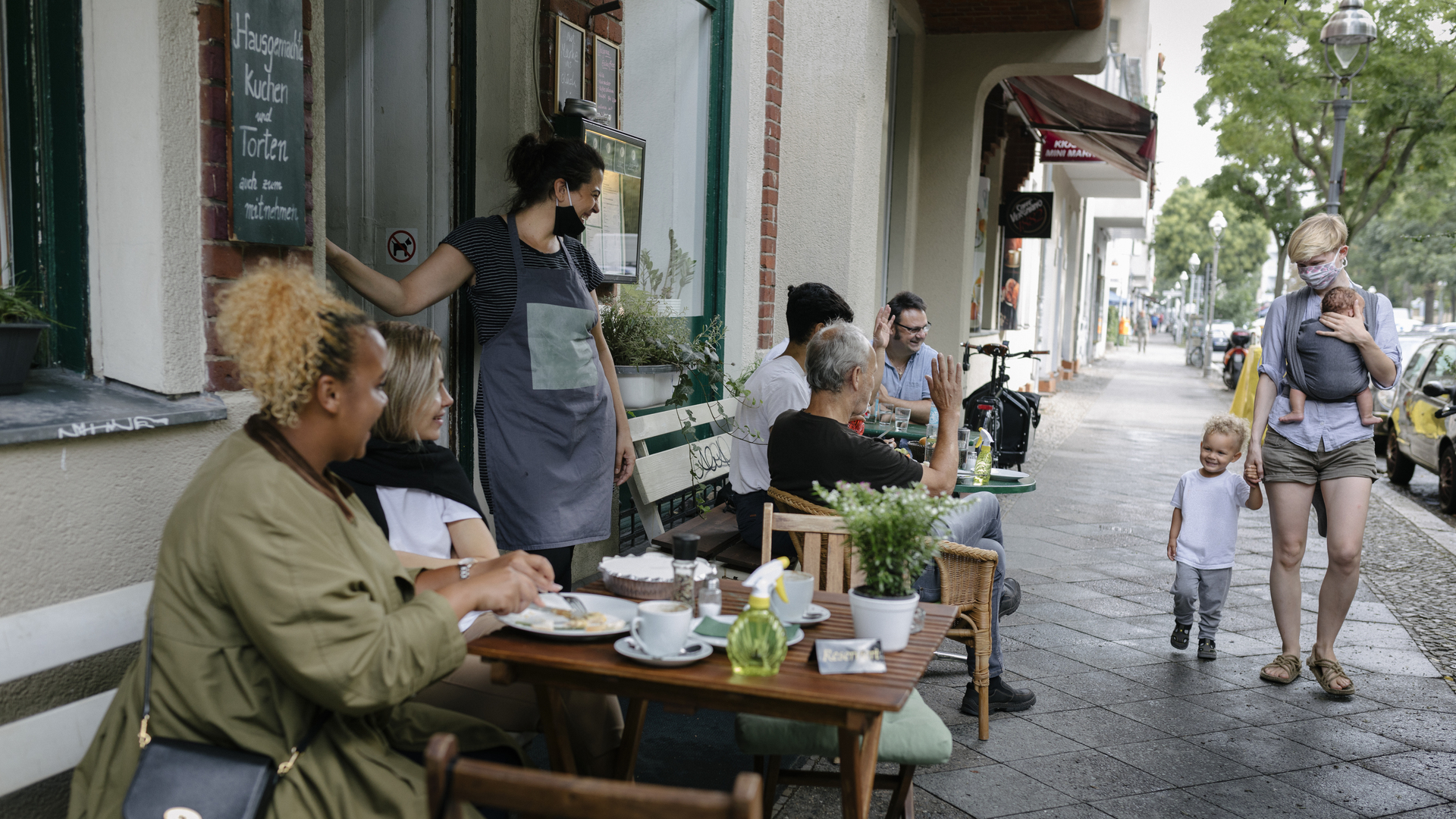 Owner welcoming customers at reopened restaurant