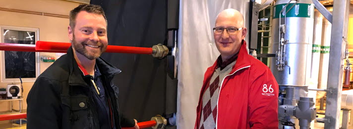Anders Nilsson and Bj&ouml;rn Nilsson in front of the district heat exchanger