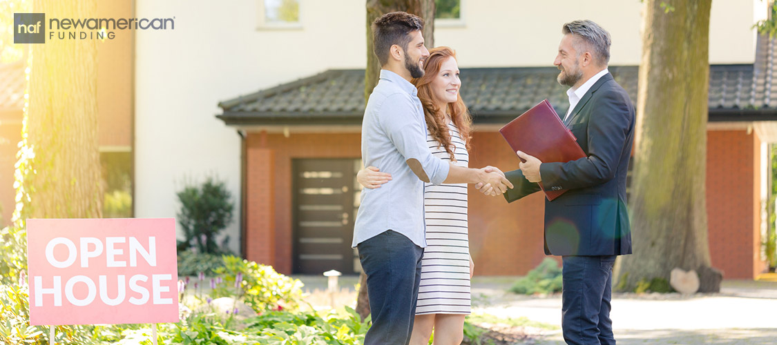 homebuyers shaking hands with real estate agent