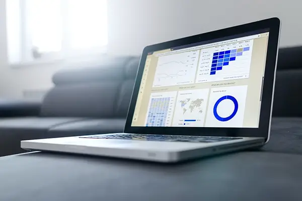 Open laptop showing screen with financial results graphics