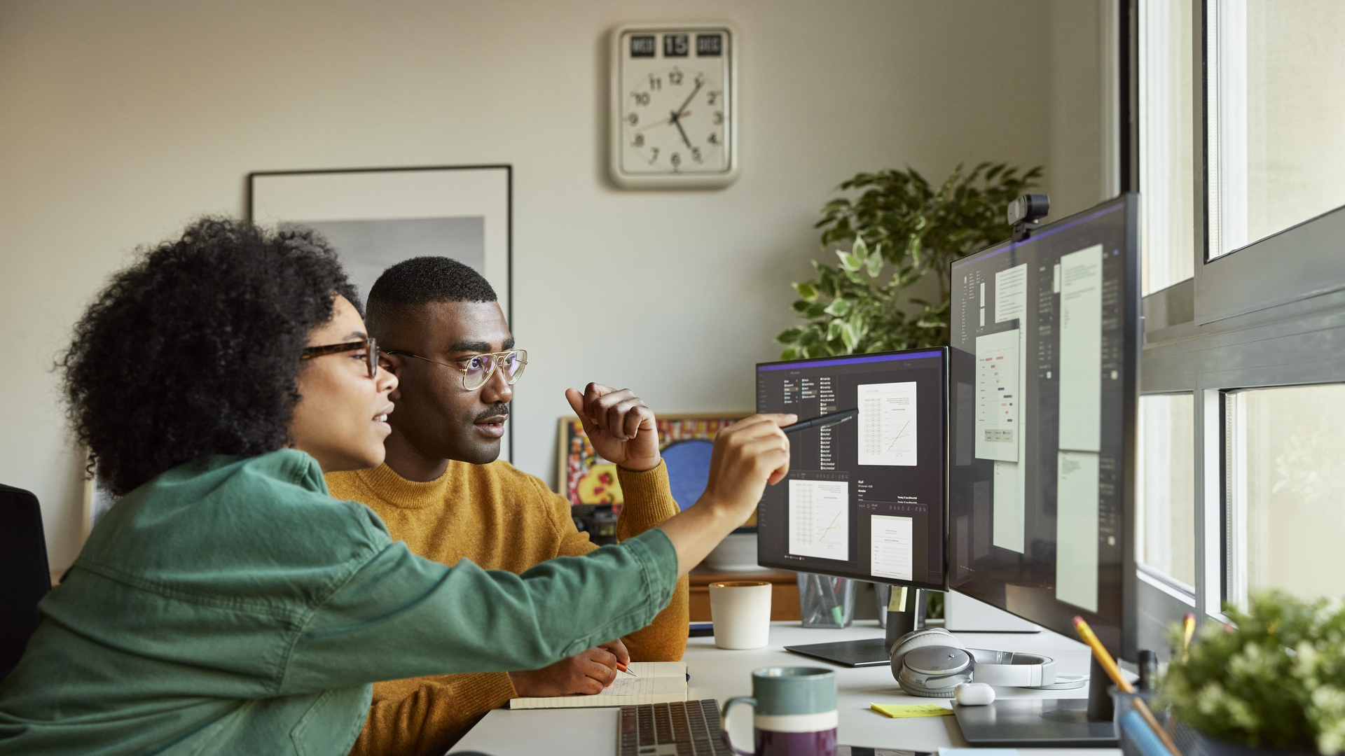 Multiracial colleagues discussing over computer