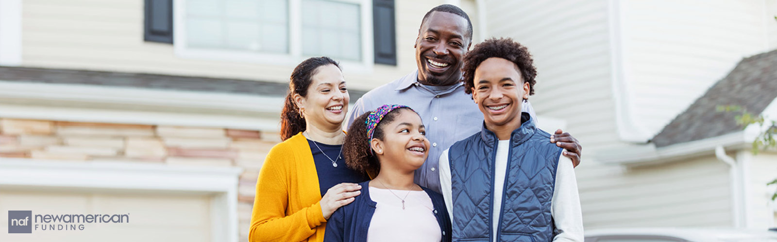 happy black family in front of their home