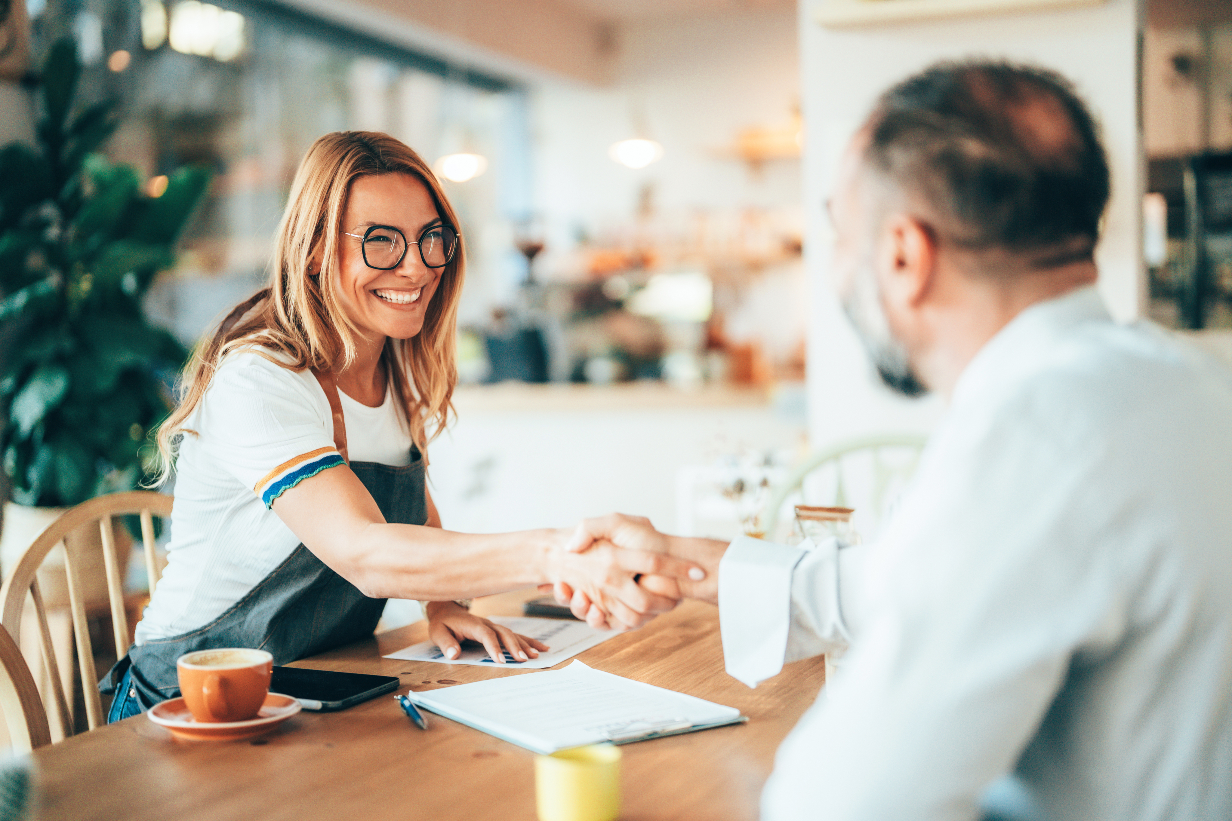 people shaking hands over a table