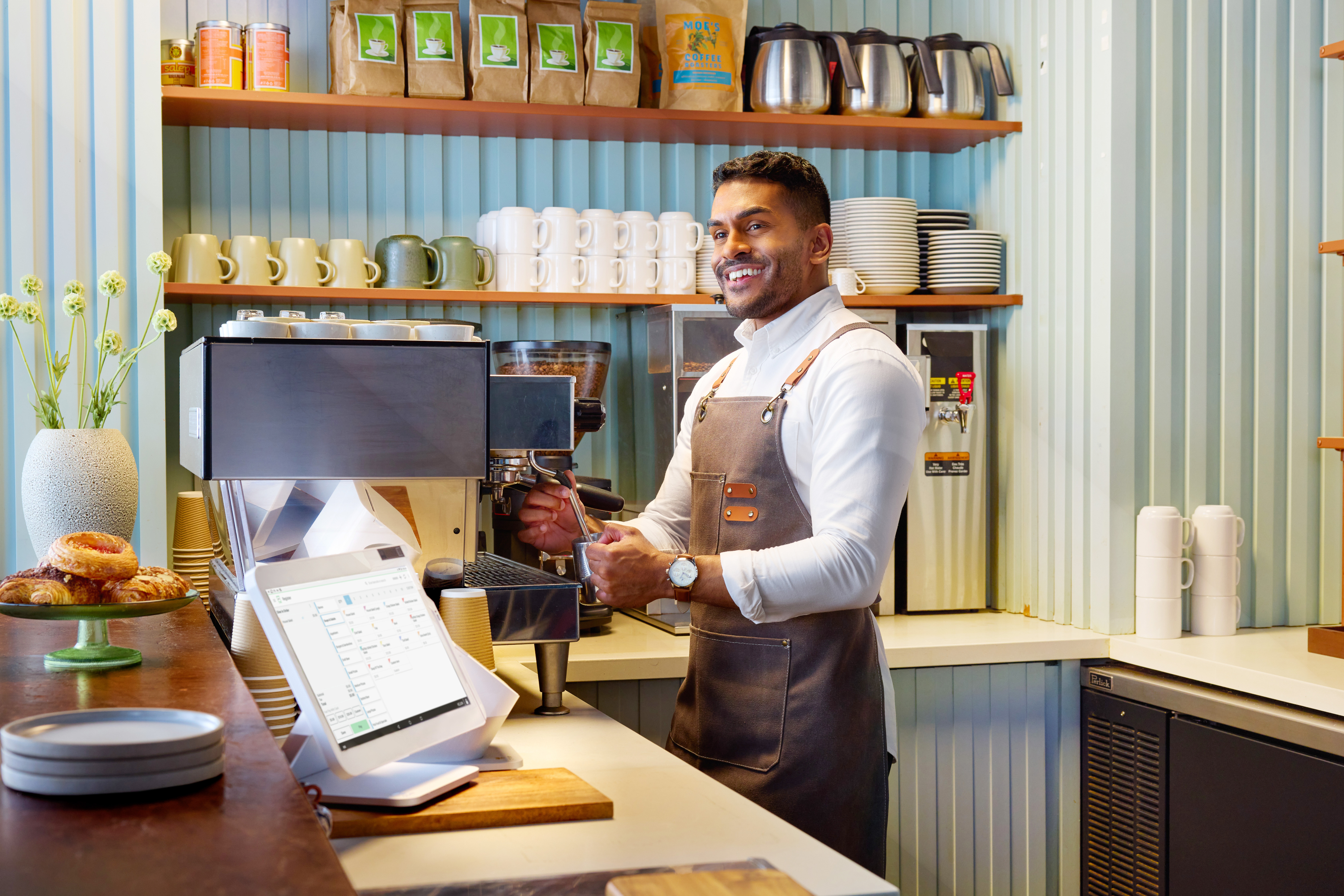 barista standing behind register