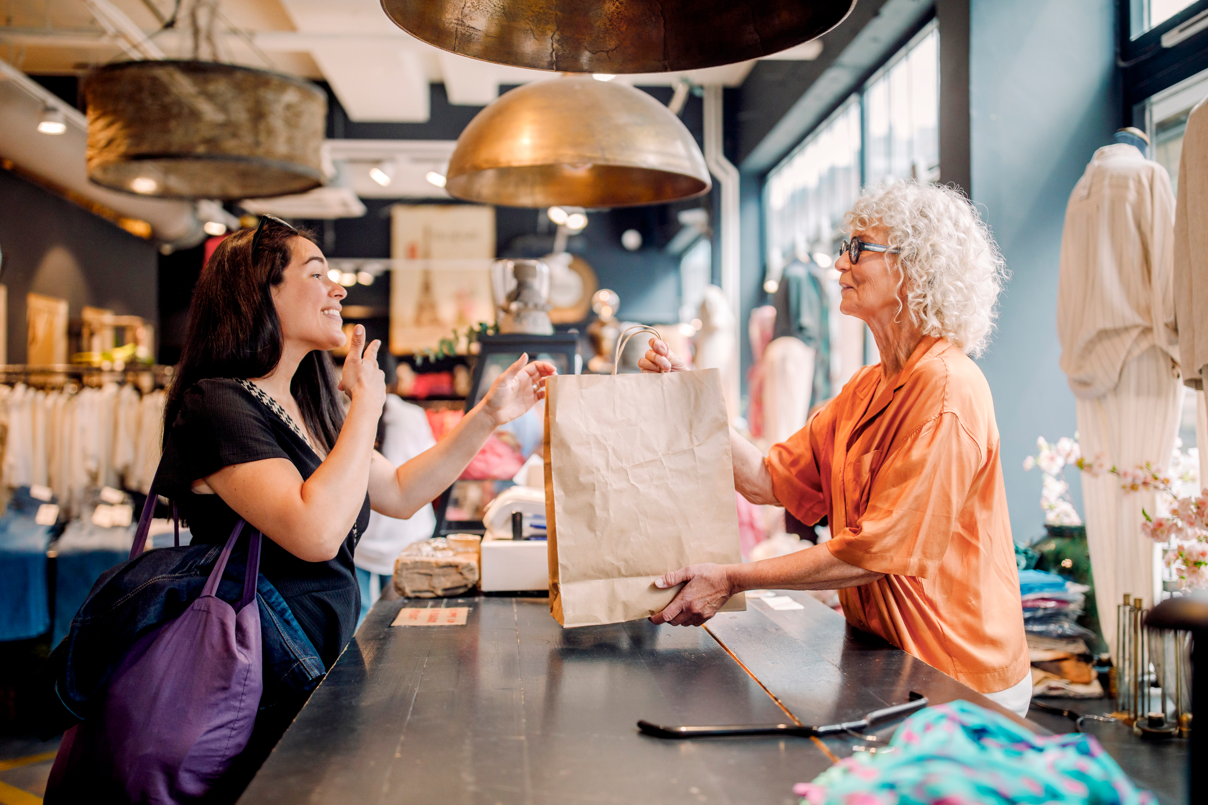employee handing customer merchandise 