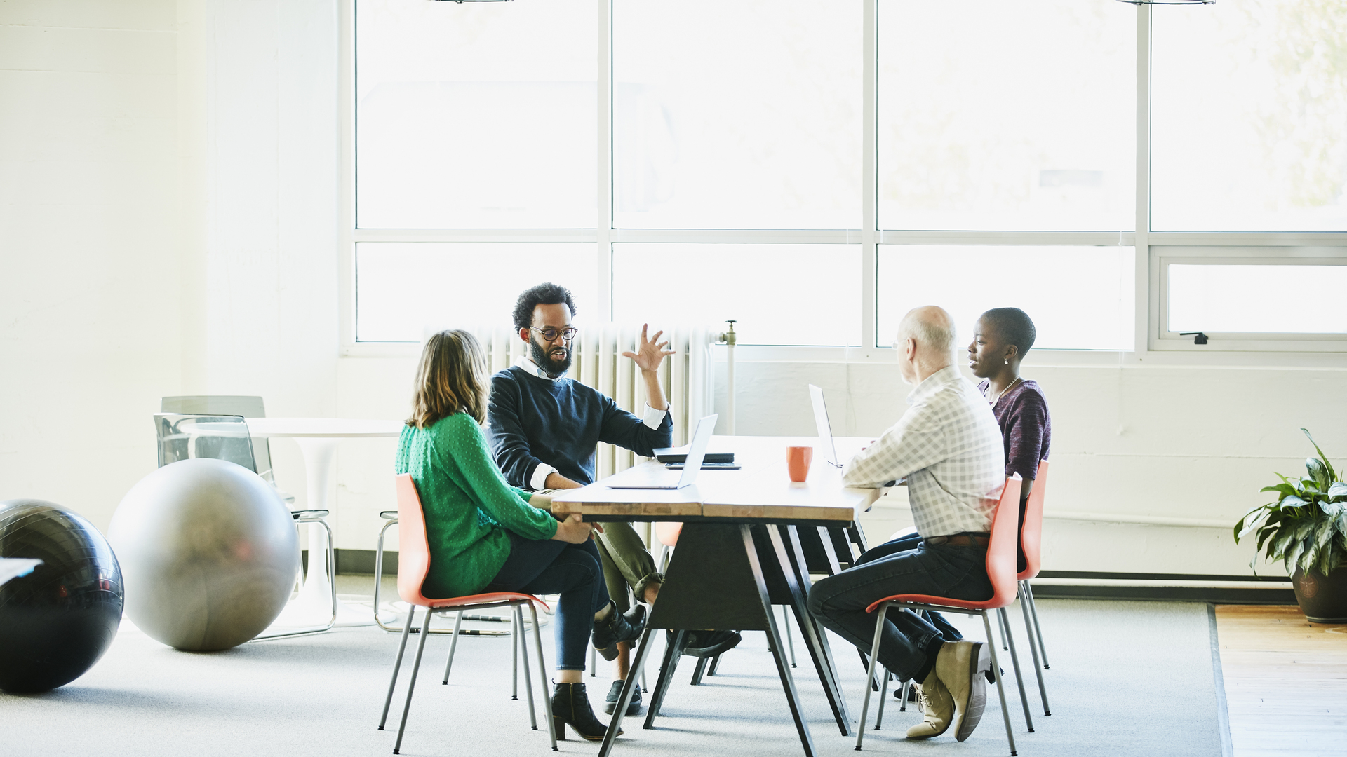 Businessman leading team discussion during meeting at office conference room