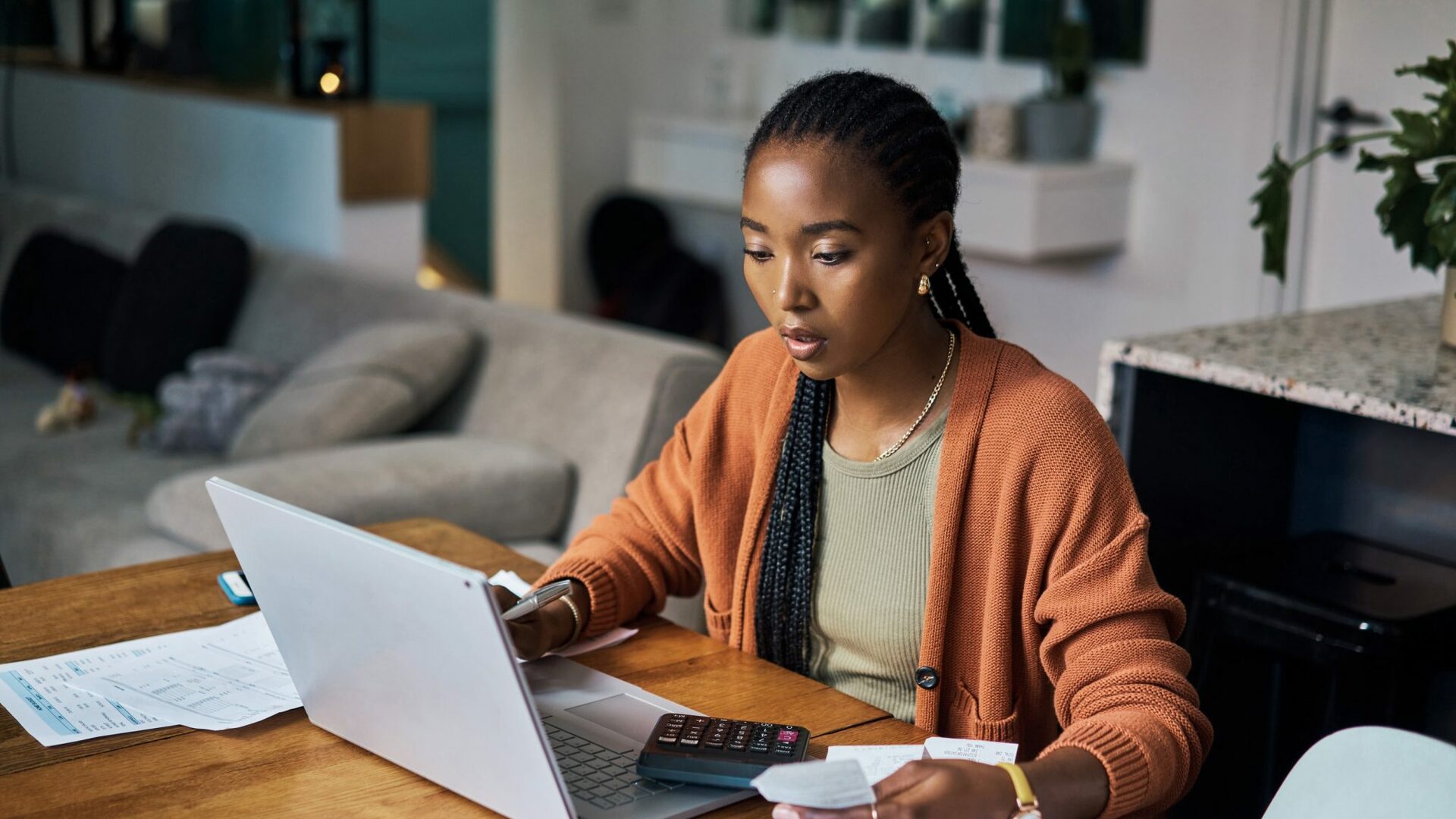 Woman working on budget and home finance on laptop for accounting.