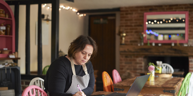 Cafe owner doing her paperwork