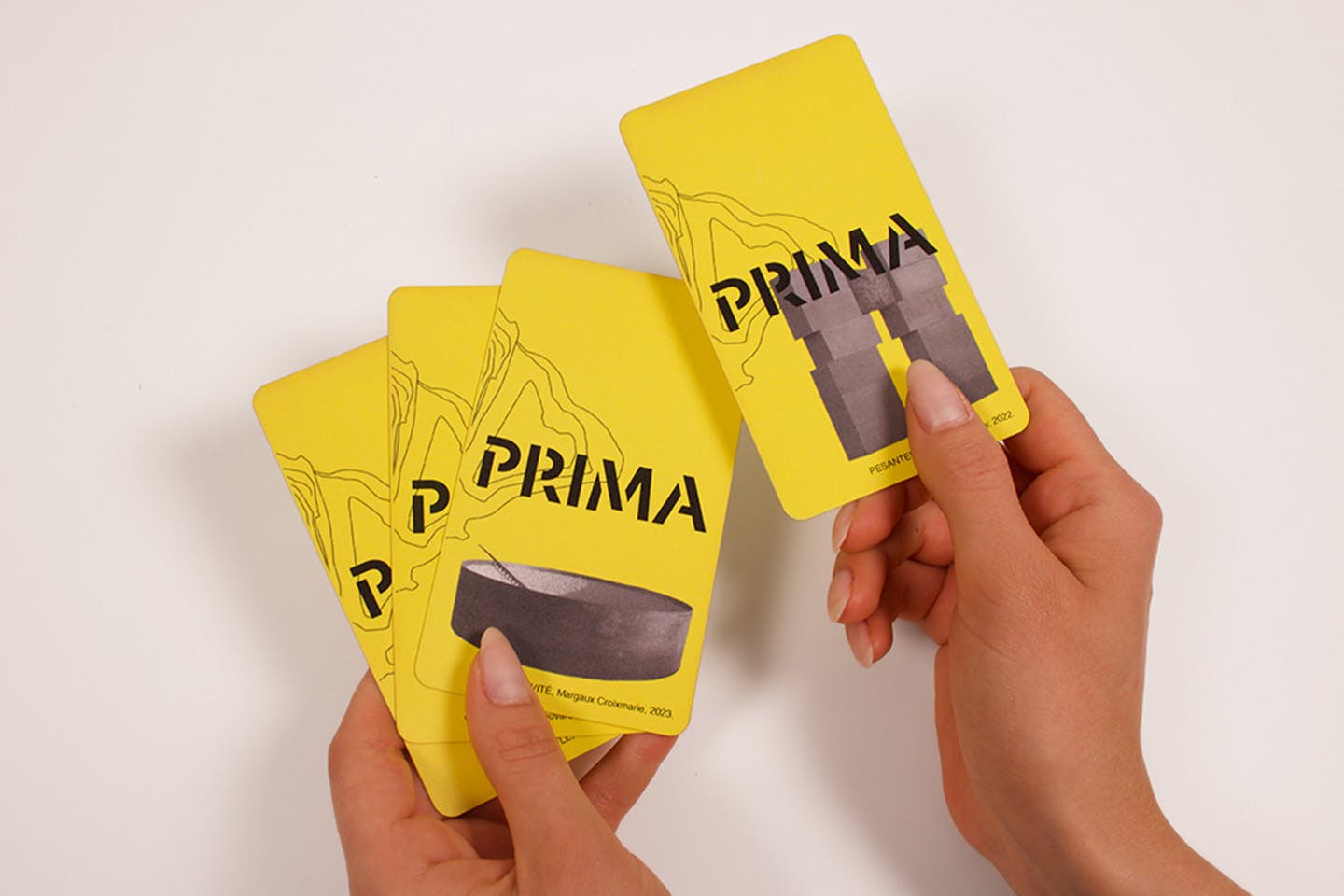 Two hands hold a yellow foldable map of the PRIMA park, designed by students to support visitor navigation and interpretation.