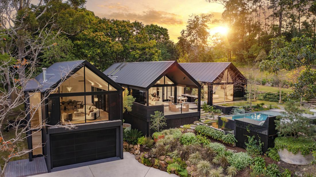 An arial shot of a house showing a pool and 3 sections of the house