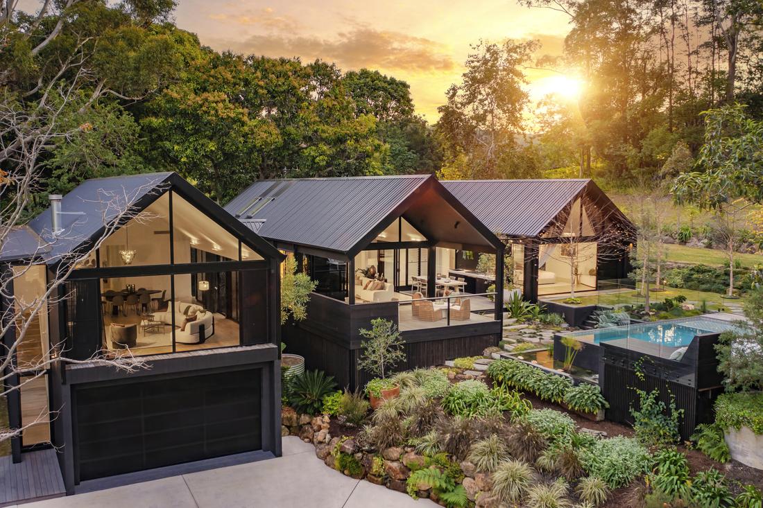 An arial shot of a house showing a pool and 3 sections of the house