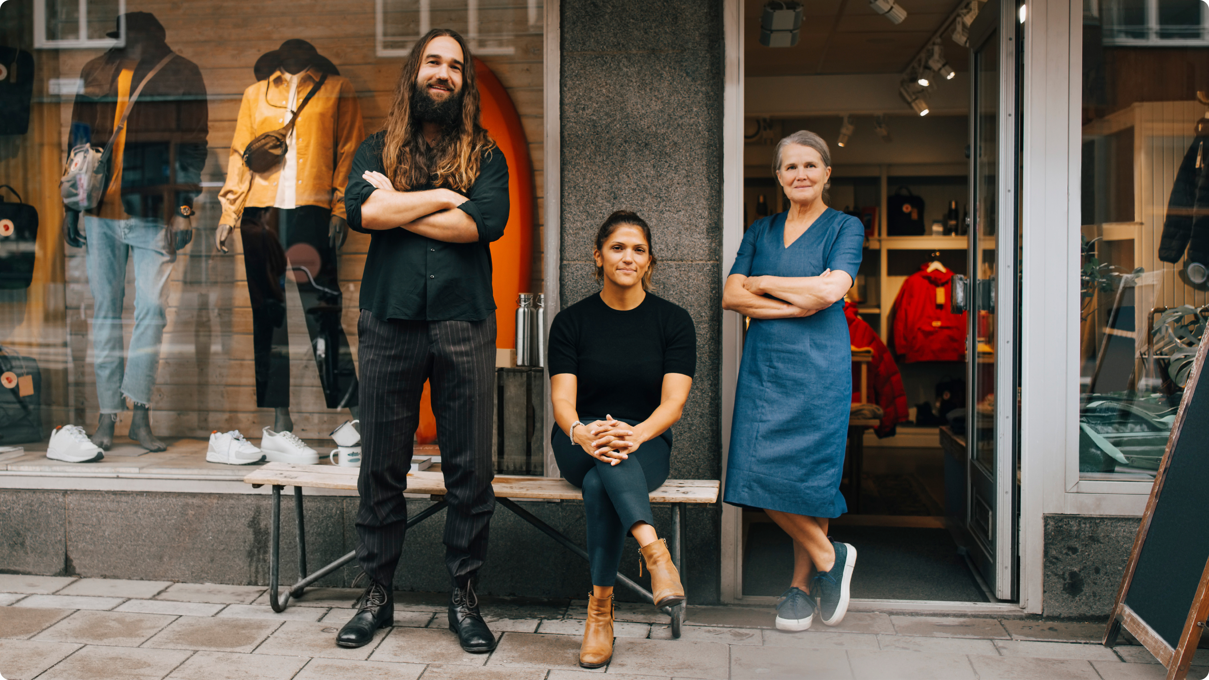 people stand outside of storefront