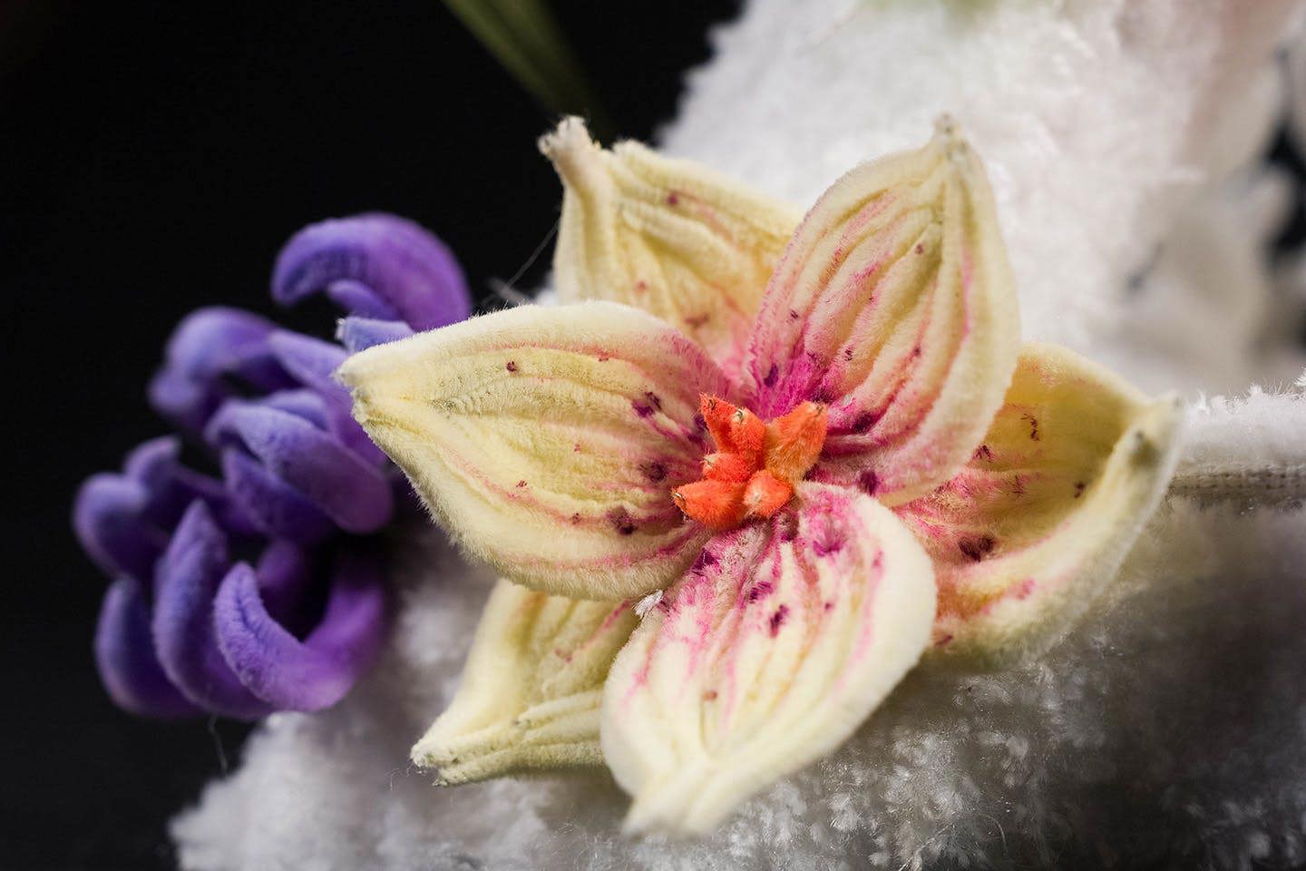 Close-up of hand-painted, multicolored petals featured in Chen’s textile pyramid installation