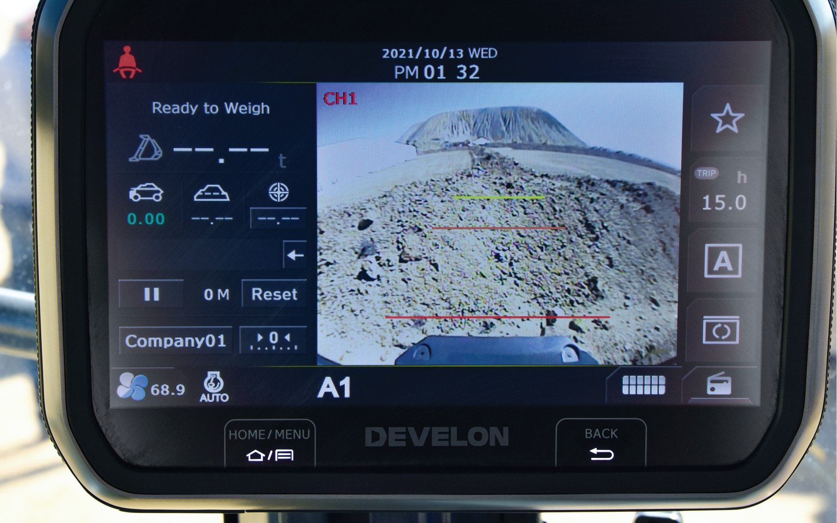 Material weighing data is shown on an in-cab display screen.