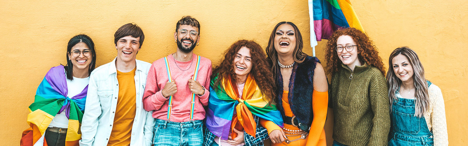A diverse group of people celebrates pride together 